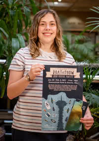 Abigail Chiaradia holding her poster design