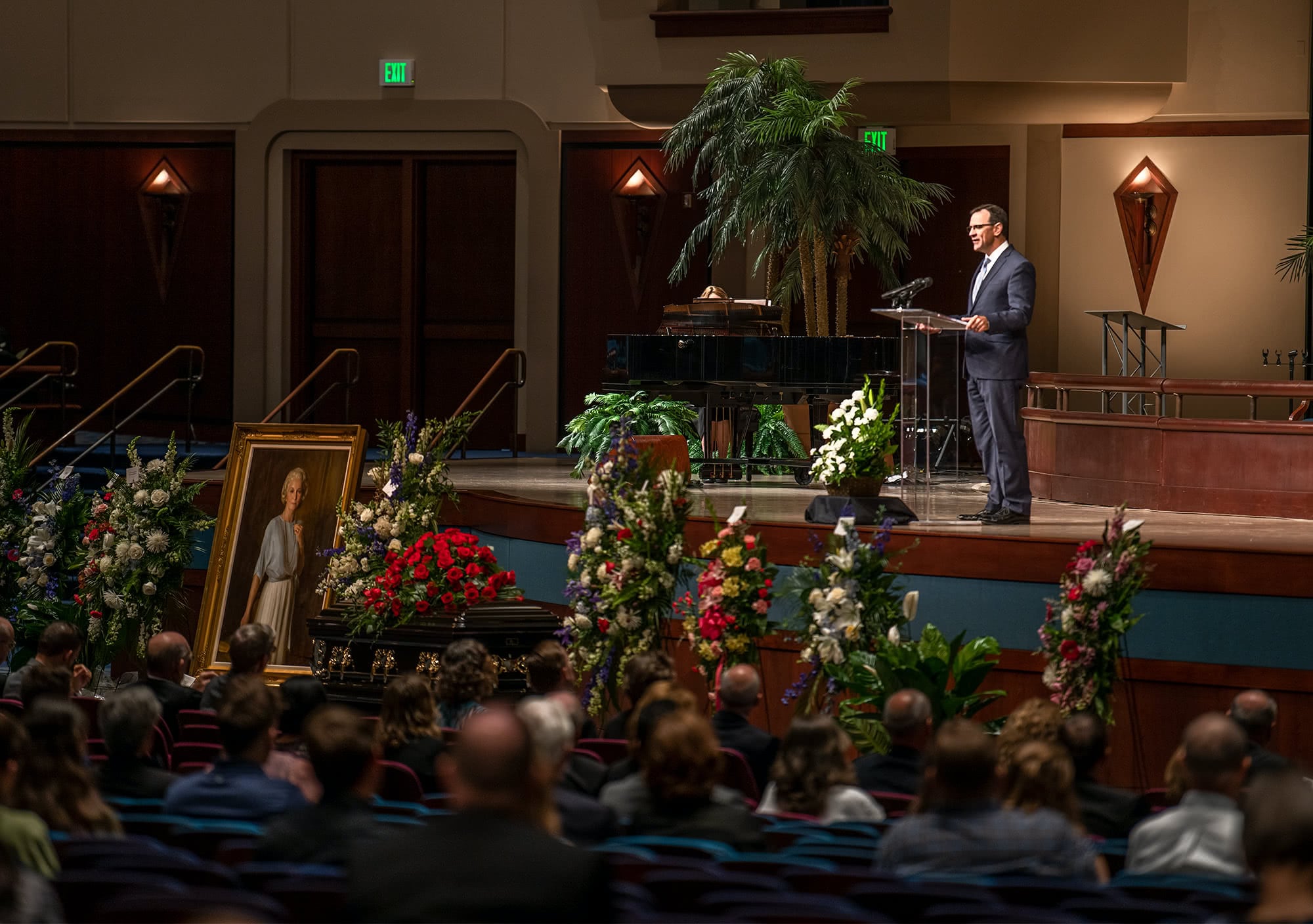 Pastor Redlin speaking on stage at the memorial. 