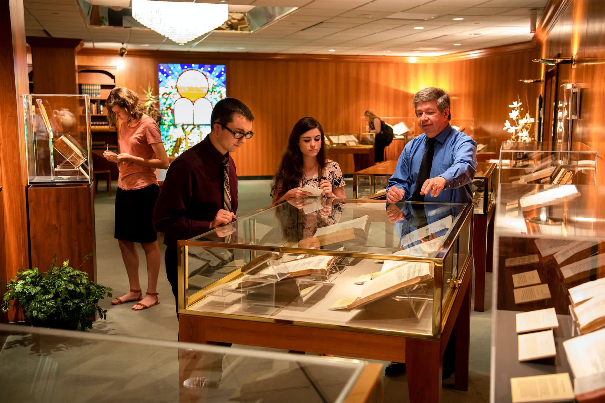 People viewing artifacts in Bible Manuscript Room