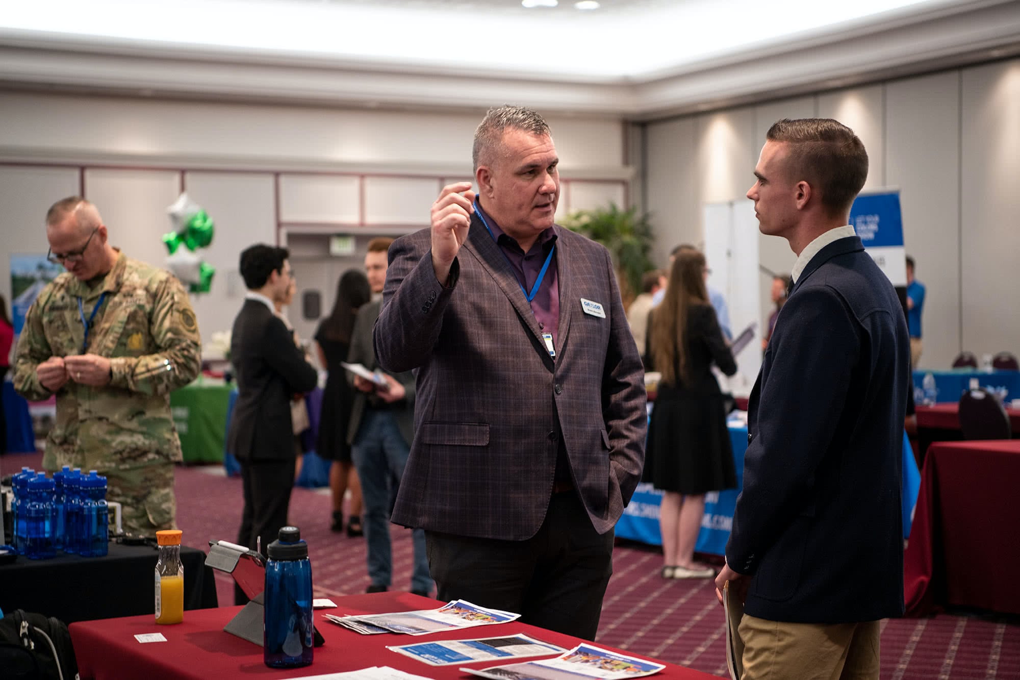 PCC senior speaking at a booth with a business representative at the 2020 Career Fair. 