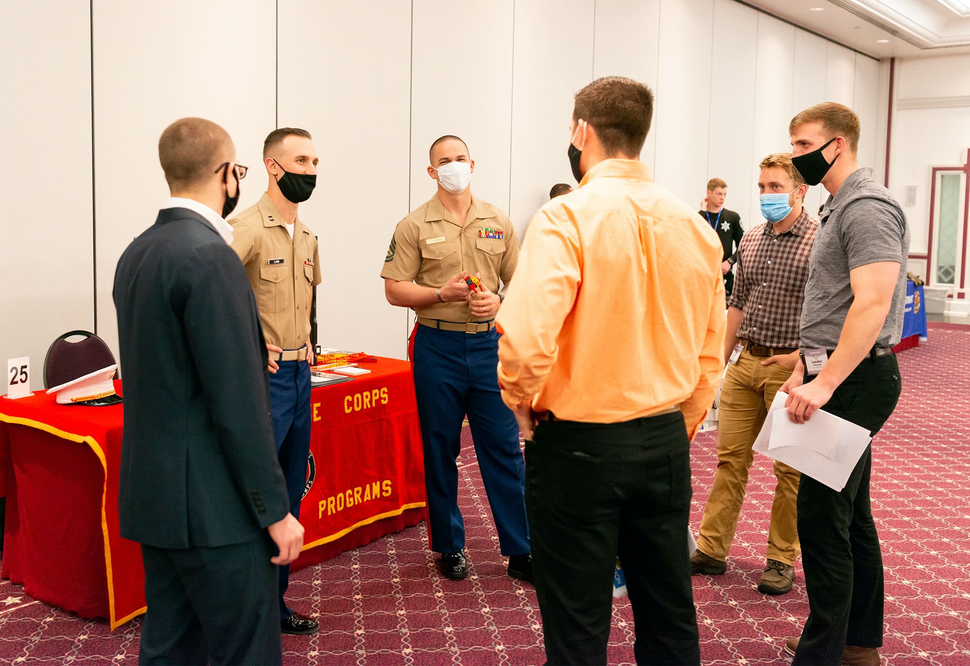 Four male students meet with recruiters from the U.S. Marine Corps.