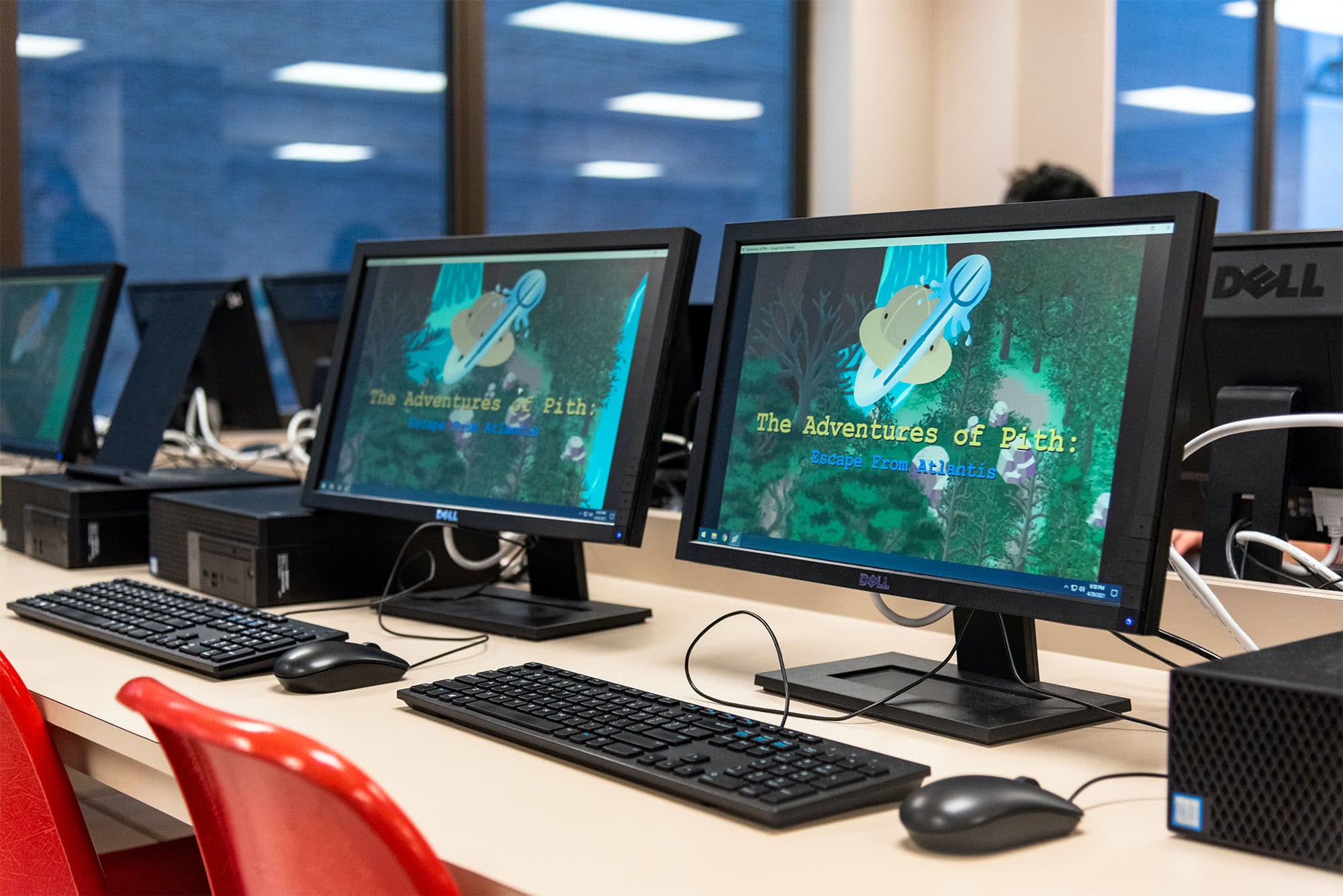 Two computer screens showing a student-created game at the Software Expo.