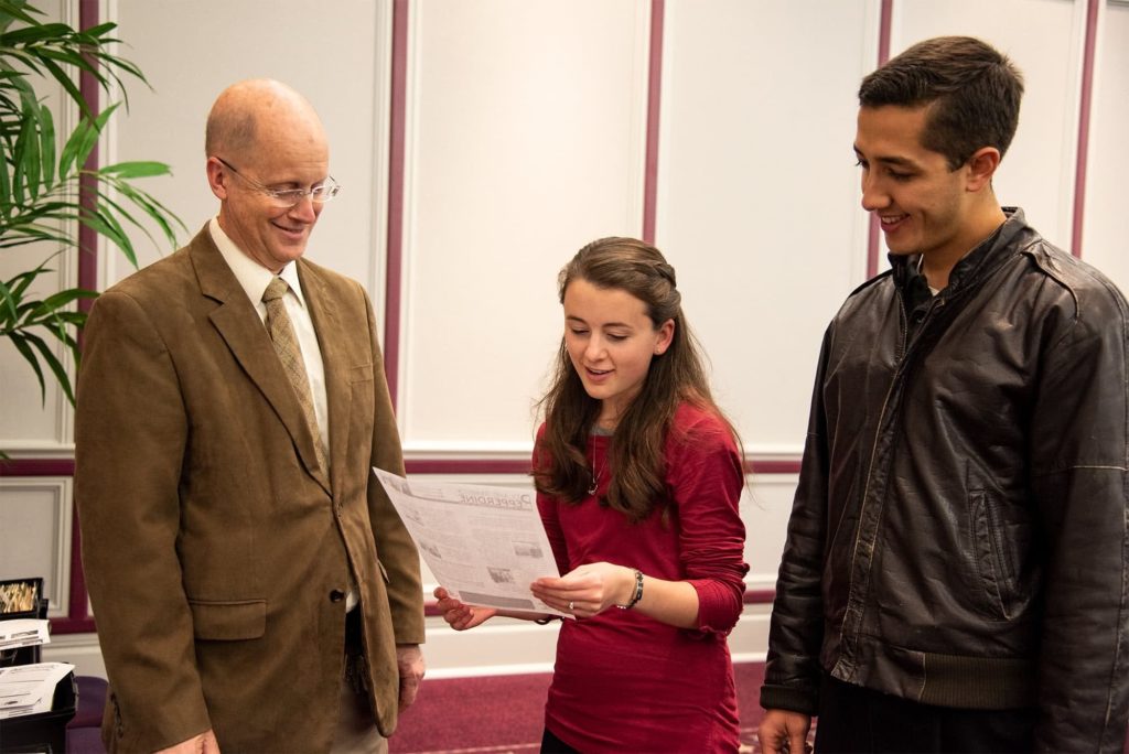 Dr. Bucy talks to a couple students about the mission field