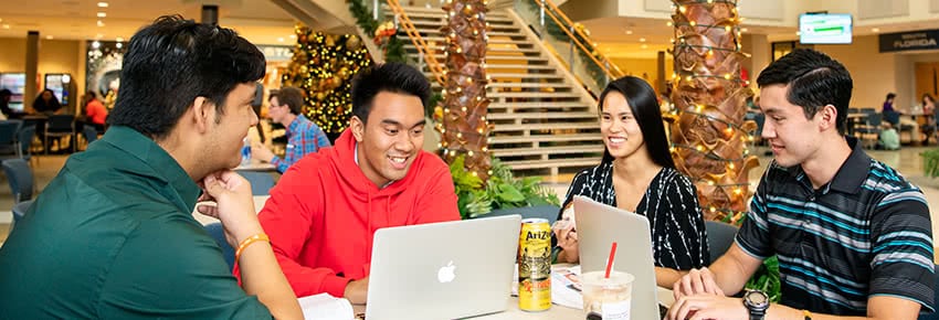 A group of friends studies together in the Commons