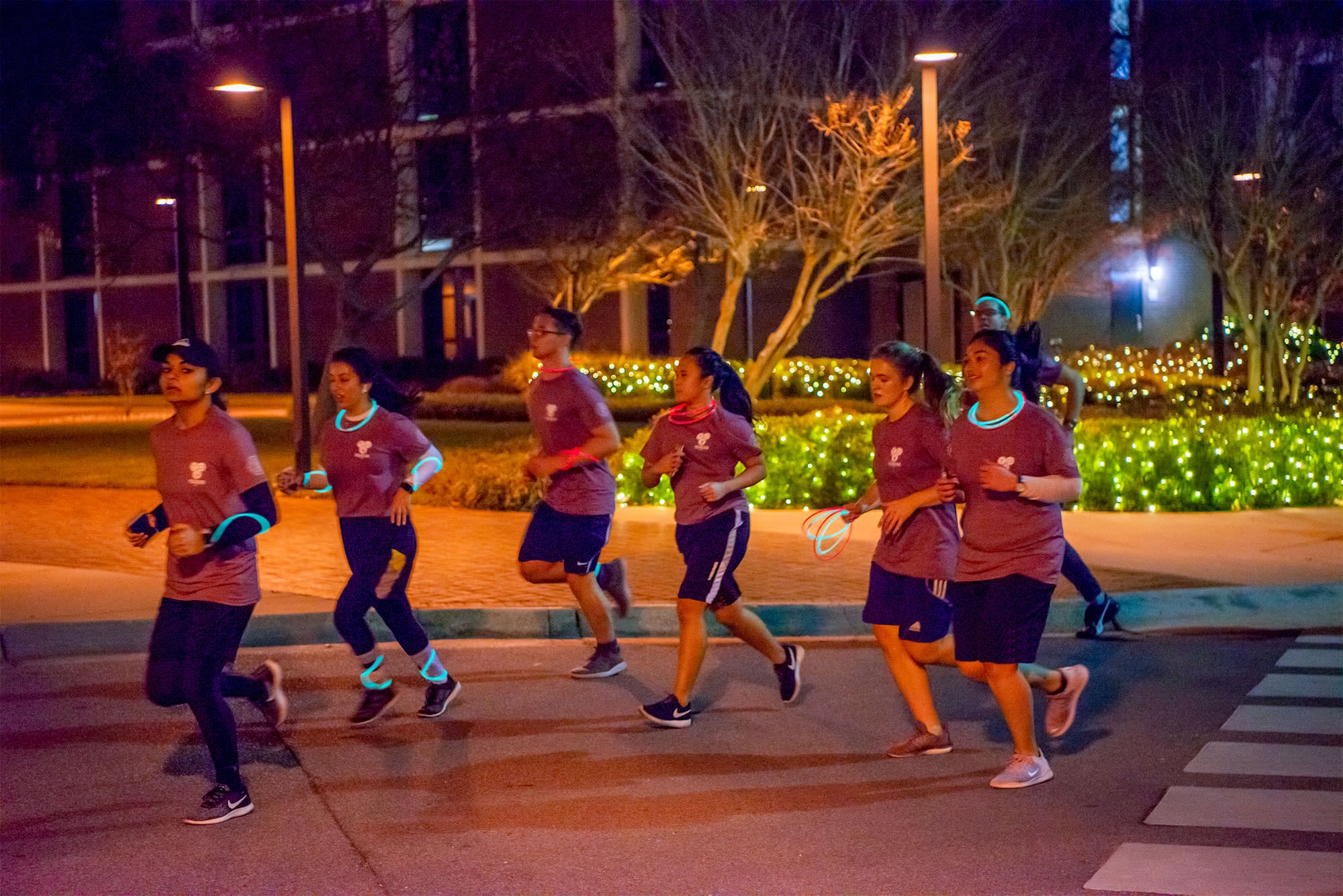 A group of students pass Bradley Tower as they run