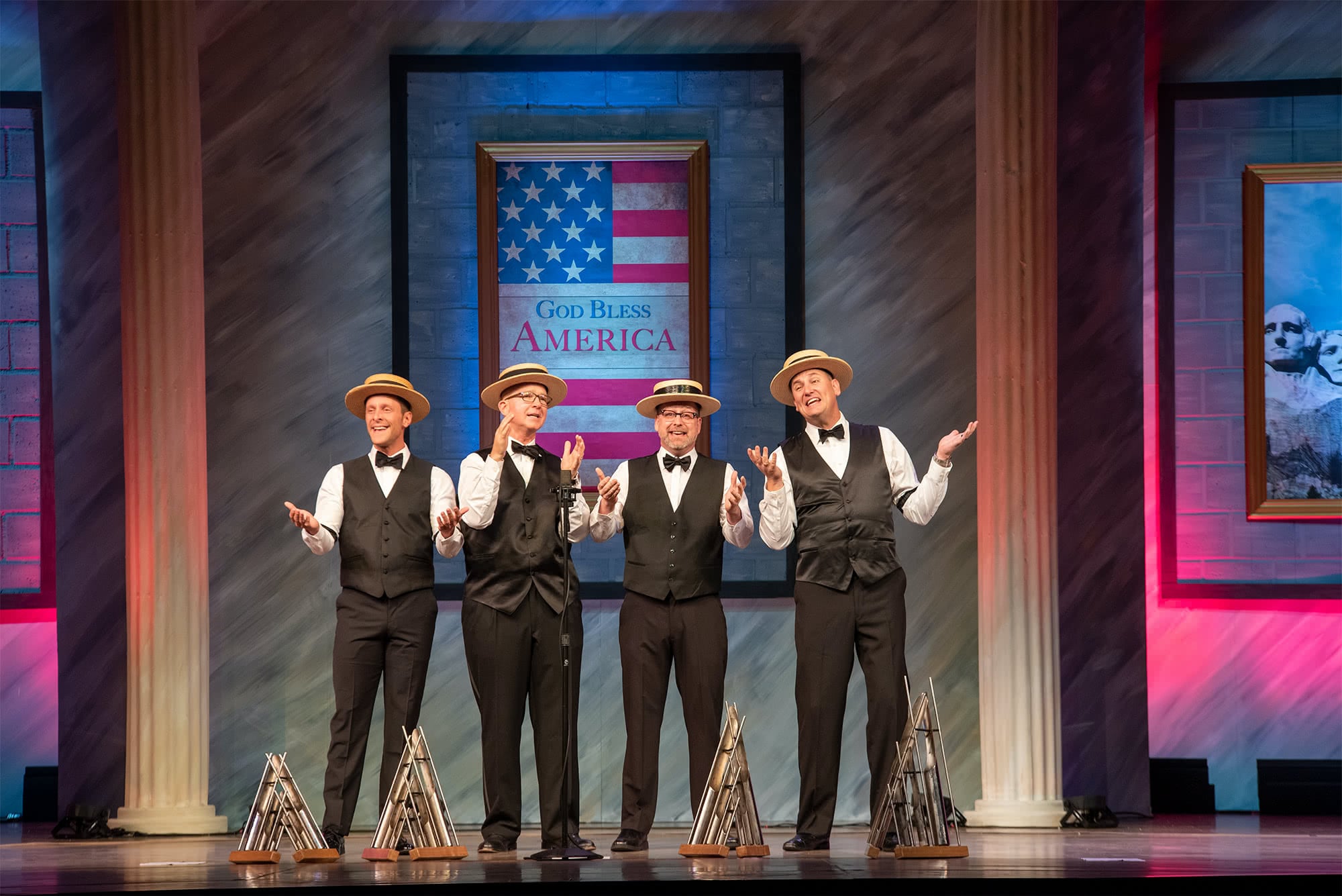 The Humdingers barbershop quartet wearing hats and vests and singing.