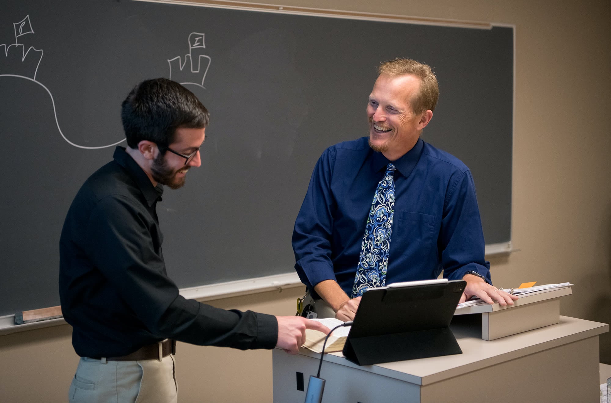 Professor smiling at graduate student.