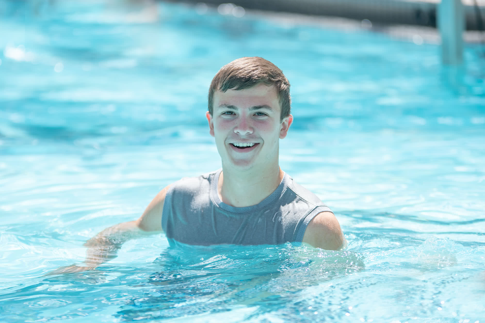 Male student swimming in the PCC Swim Center.