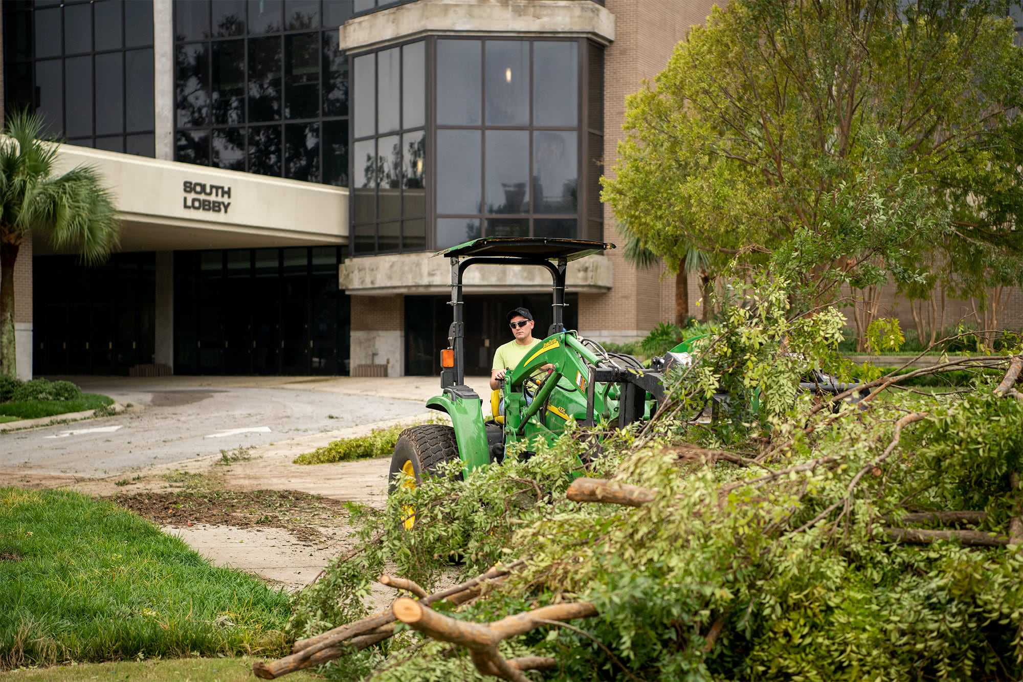 Grounds workers use tractors to move debris