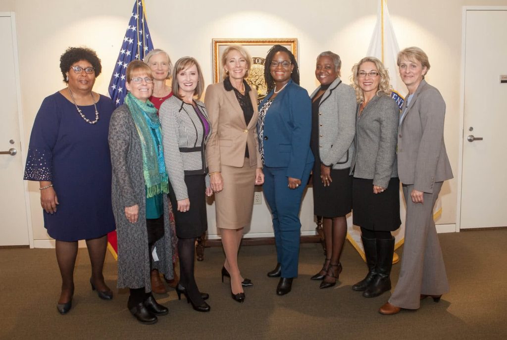 Melissa Newport standing and smiling with a group of women. 