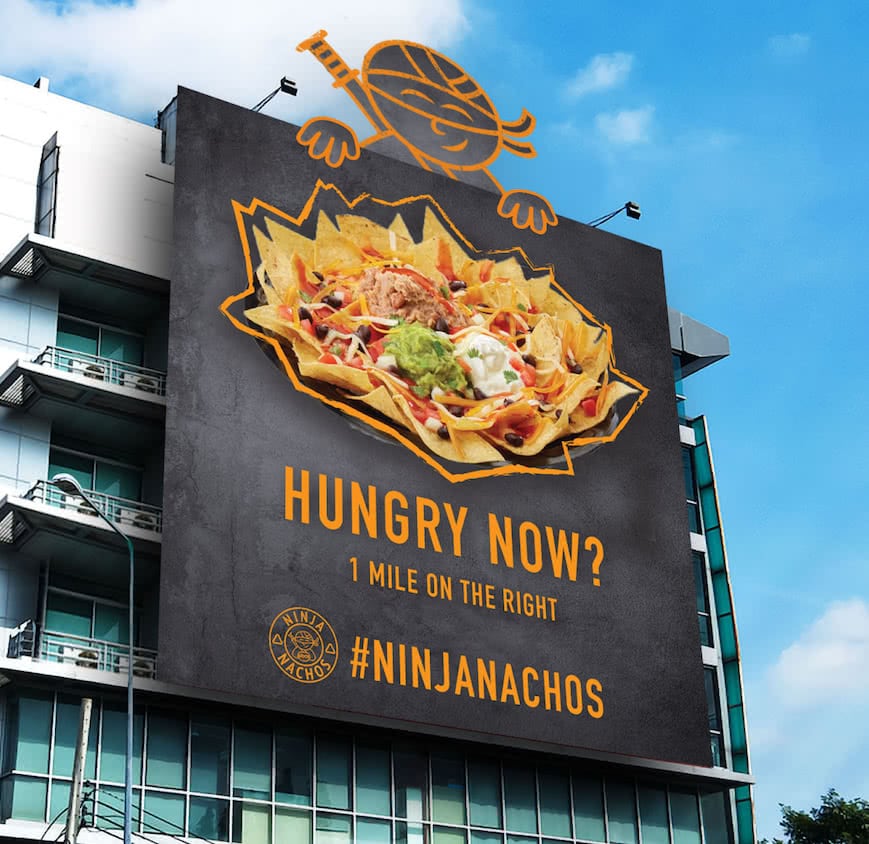 The billboard for ADDY award winner Daniel Garcia's advertising campaign shows a plate of nachos with the ninja logo protruding from the top.