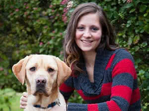 Rachel Chamness posing with a guide dog. 