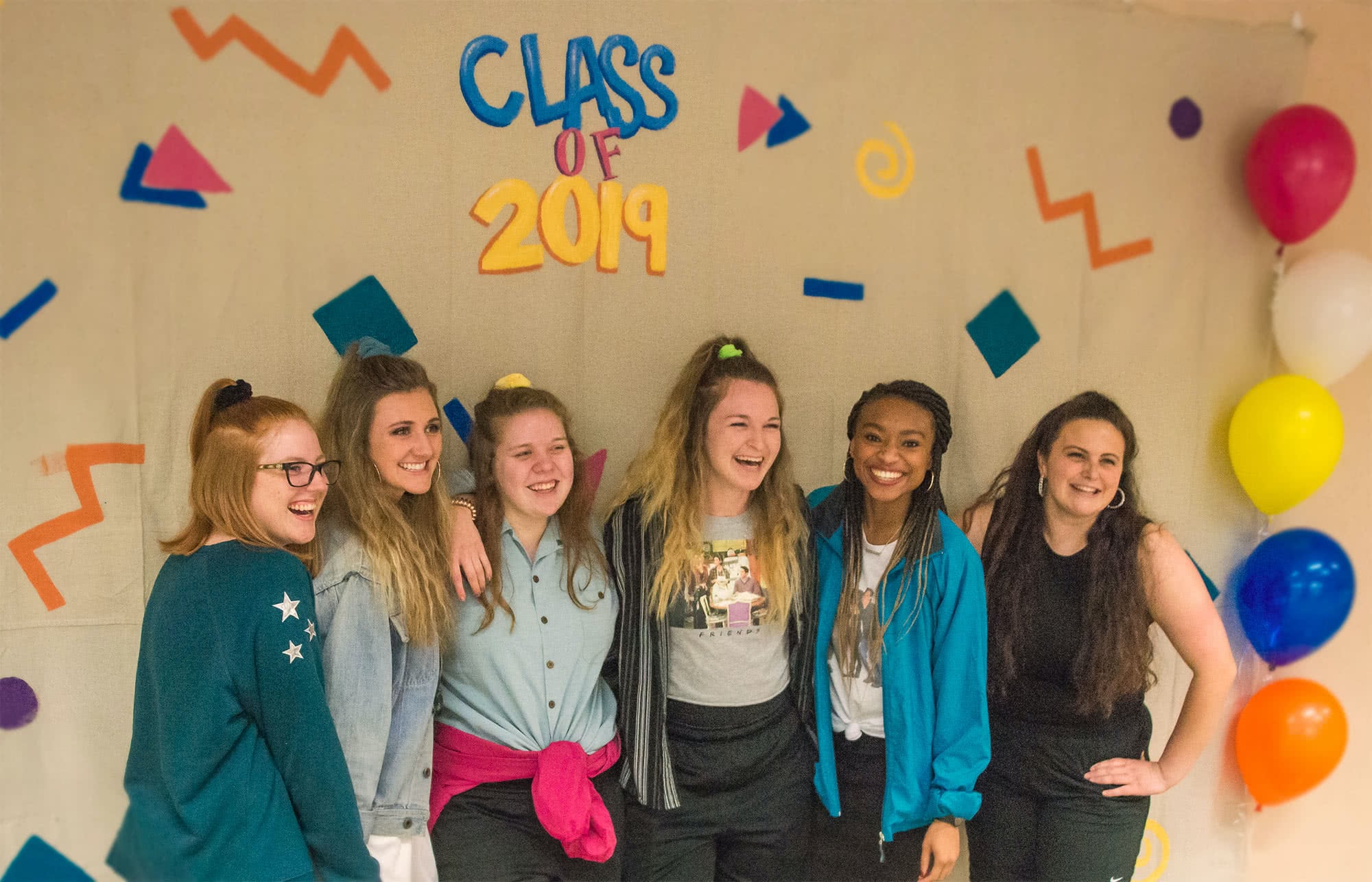 Female students posing for a photo at their senior class party.