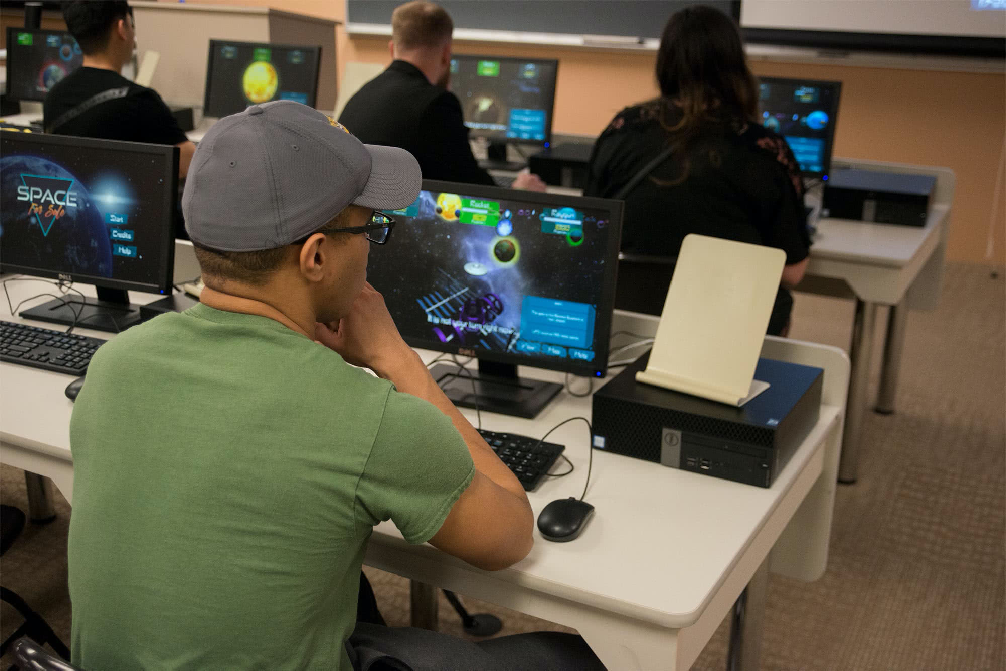 Male student playing a student-created video game. 