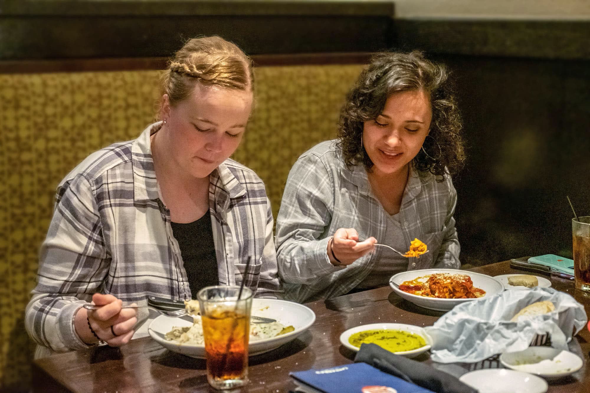 Two female students eating their meals at Carabbas. 