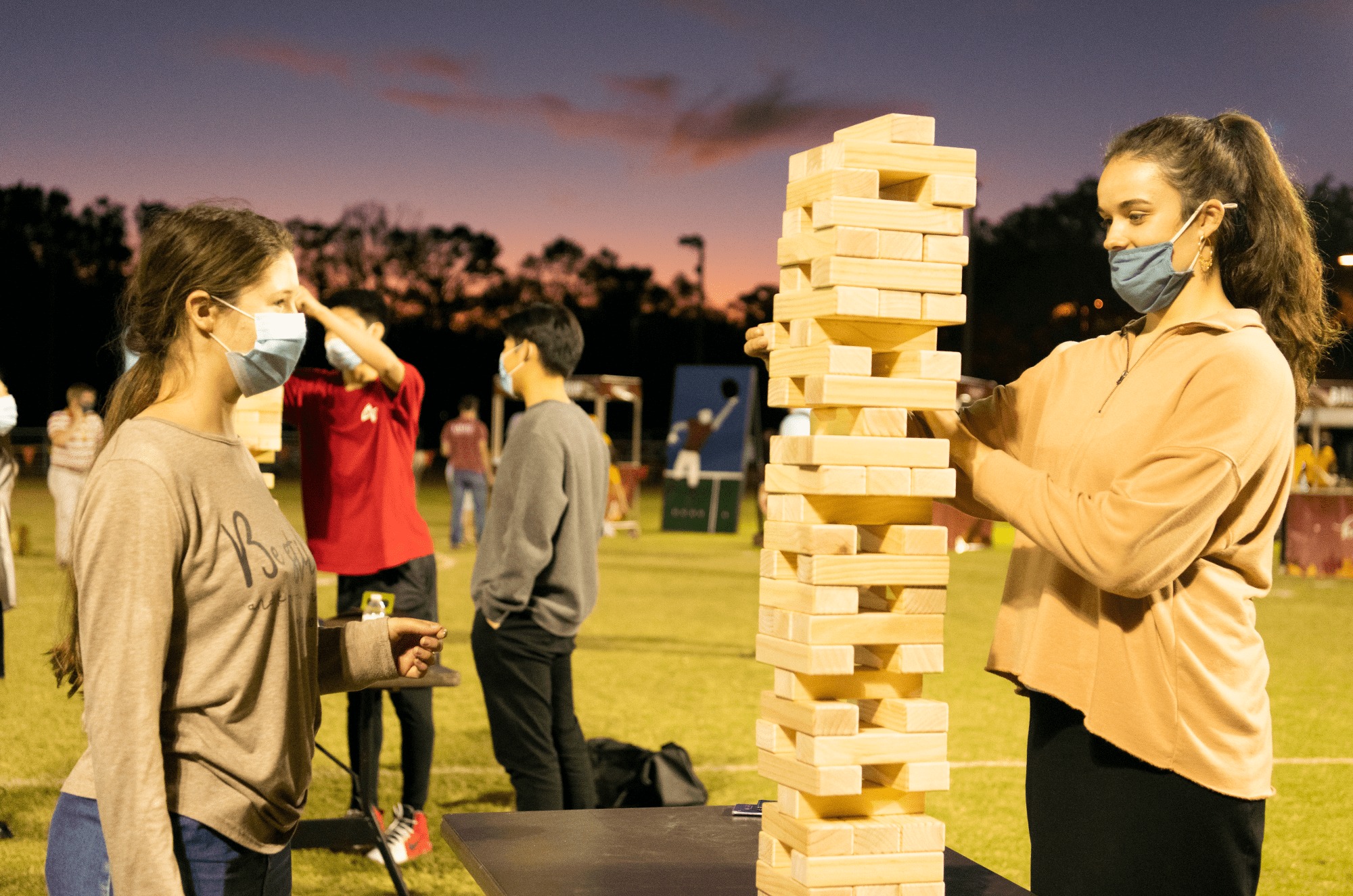 Two female students playing Jenga at PCC Harvest Fest.