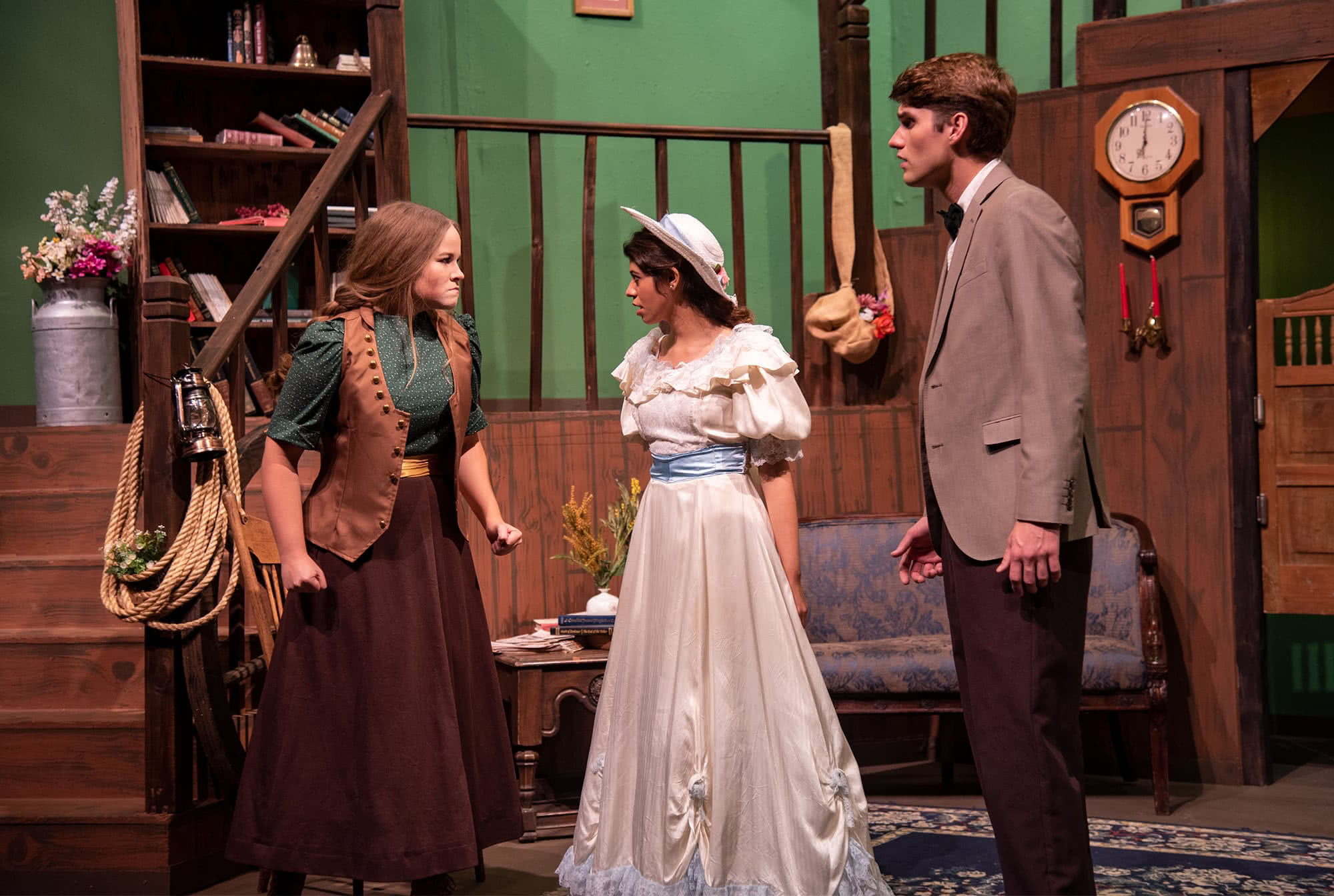 Three students participate in a dramatic production