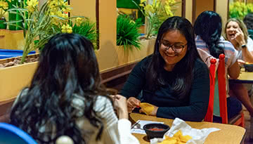 Two female students eat at a local restaurant