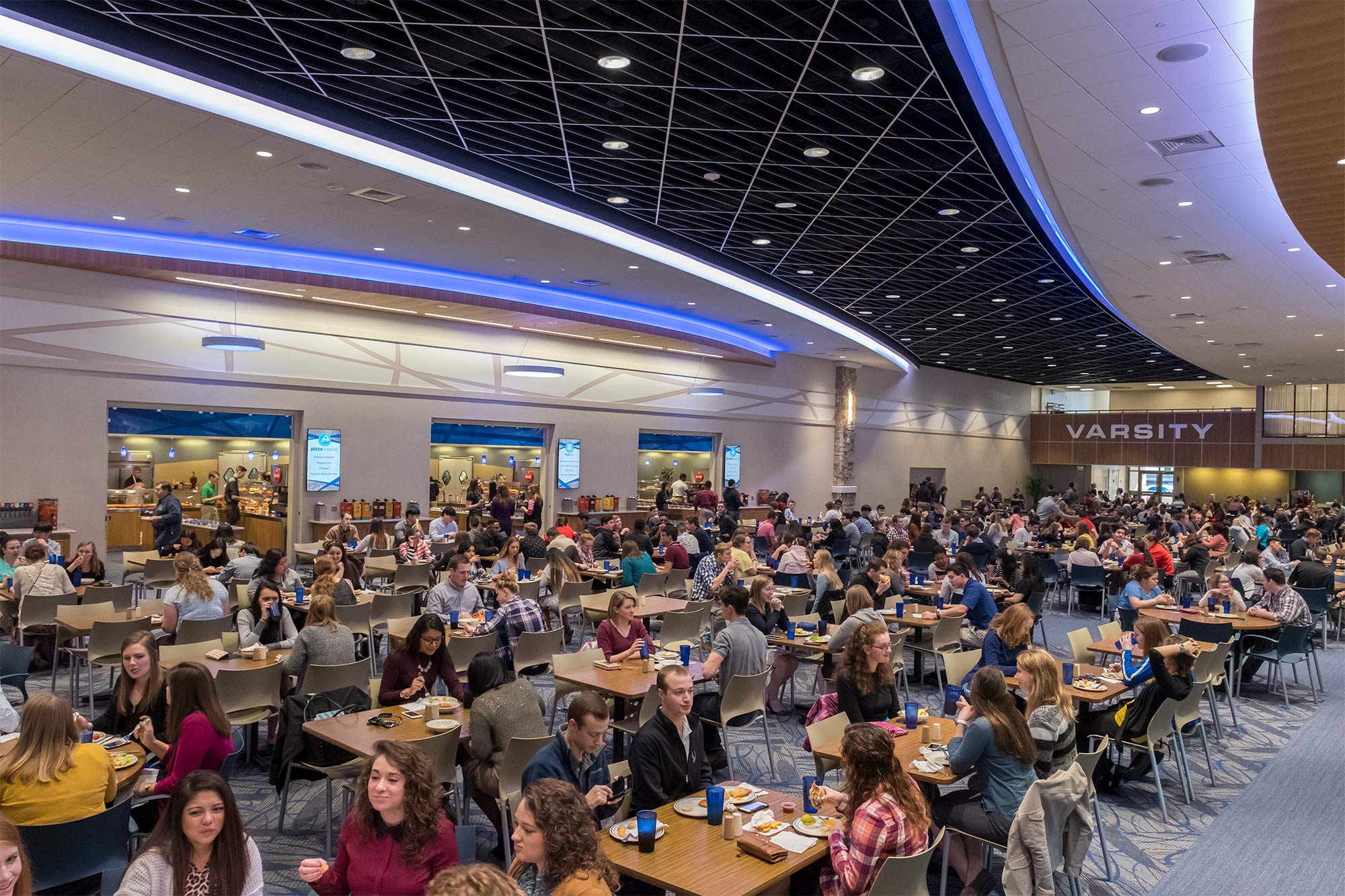 Students eating in a dining hall.