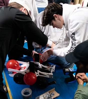 Students work on robot vehicle during Engineering Design Competition