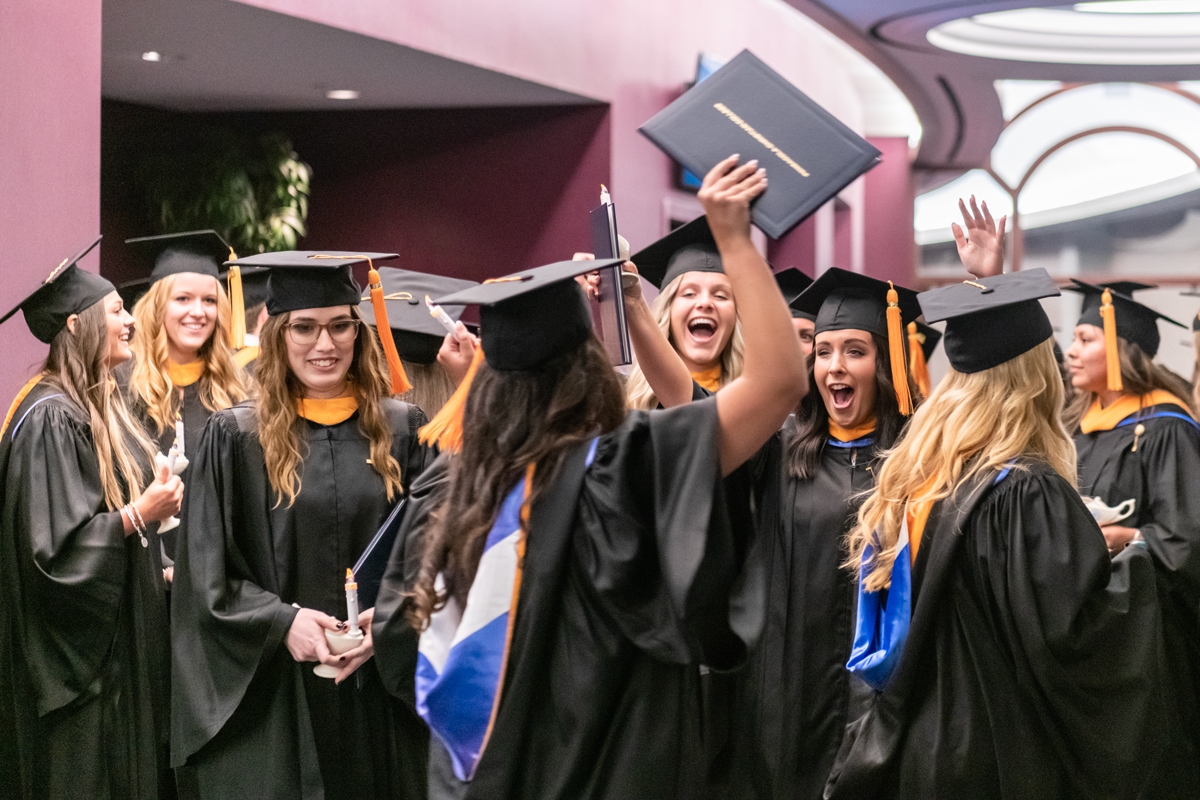 Nursing Students cheer in excitement after their graduation ceremony.