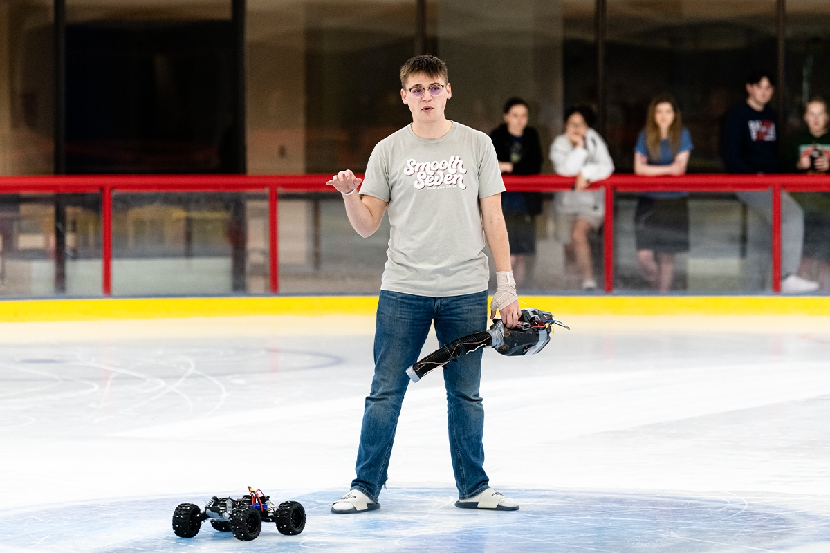 Student shows robot vehicle during Engineering Design Competition